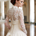 Back view of a bride in a lace long sleeve wedding gown
